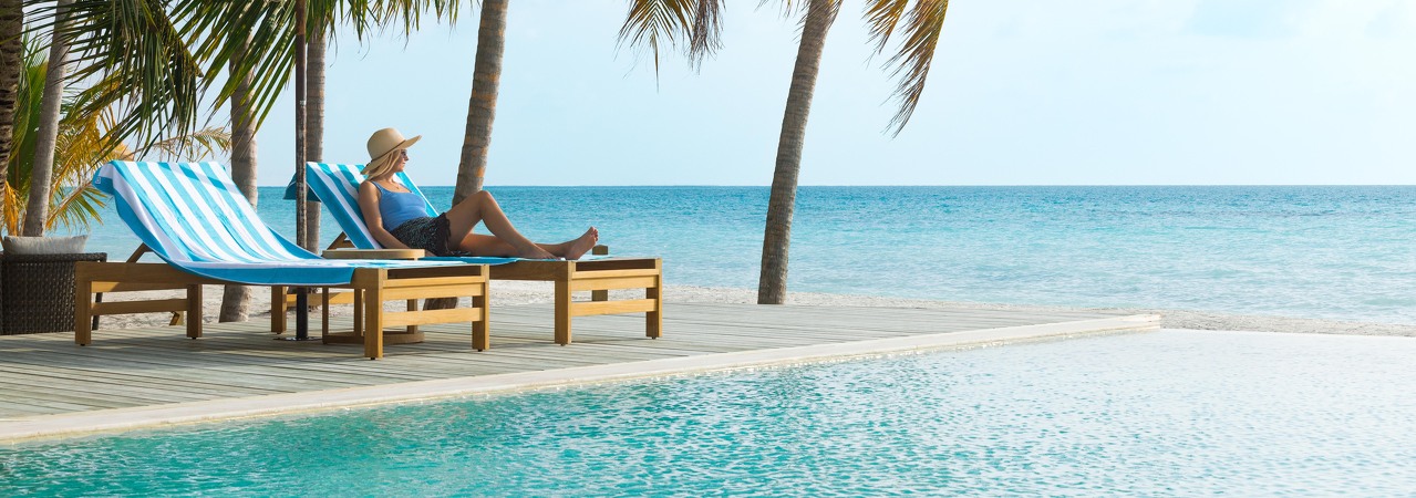 Jawakara resort Maldives poolside swimming pool palm trees ocean bar restaurant dining sunbathing lounger