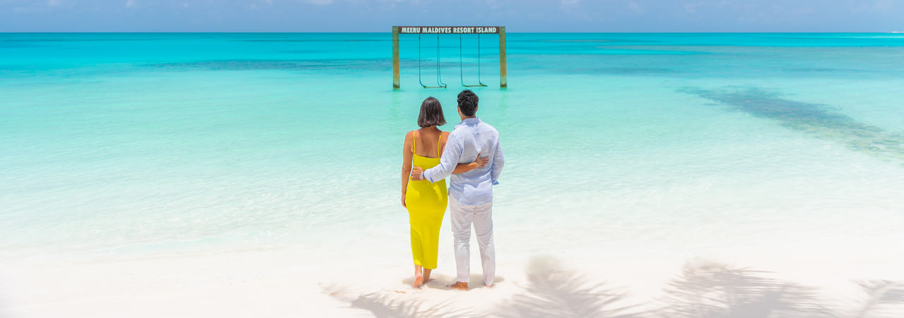 Meeru Island Resort Maldives couple lagoon swing
