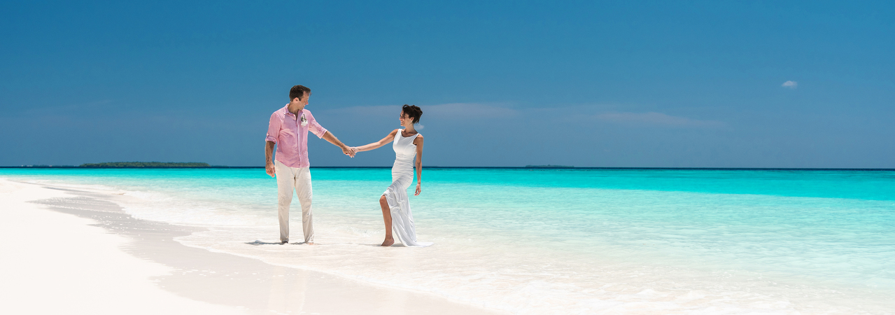 Velaa Private Island resort Maldives couple on beach