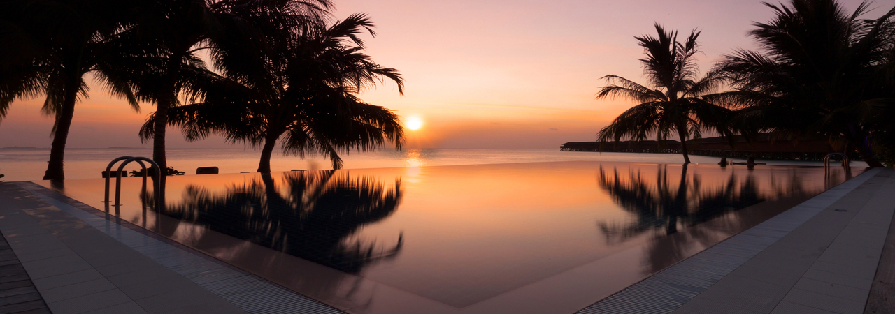 Vilamendhoo island resort maldives sunset pool bar 2